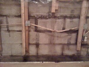 Wet concrete block wall in need of repair