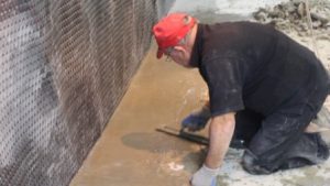 Re-installation of concrete once the drain tile and membrane have been installed