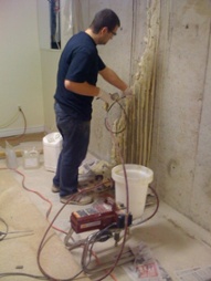 Technician performing a high pressure polyurethane crack injection