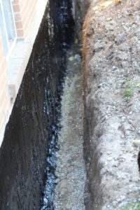 Waterproofed foundation wall