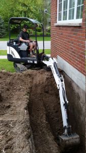 Excavation of a concrete block foundation for the purpose of waterproofing