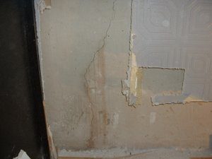Hairline crack in foundation with sediment staining
