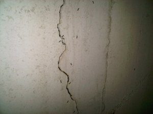 Water entering the basement through a wide foundation crack