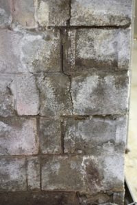 Stained and wet cinder block foundation