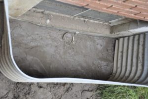 Window wells commonly fill with sediment when improperly sized and/or installed