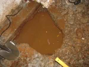 Water beneath the basement floor slab due to a high water table