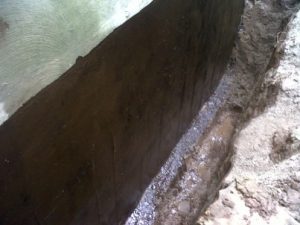 Basement foundation waterproofed with an elastomeric rubber coating